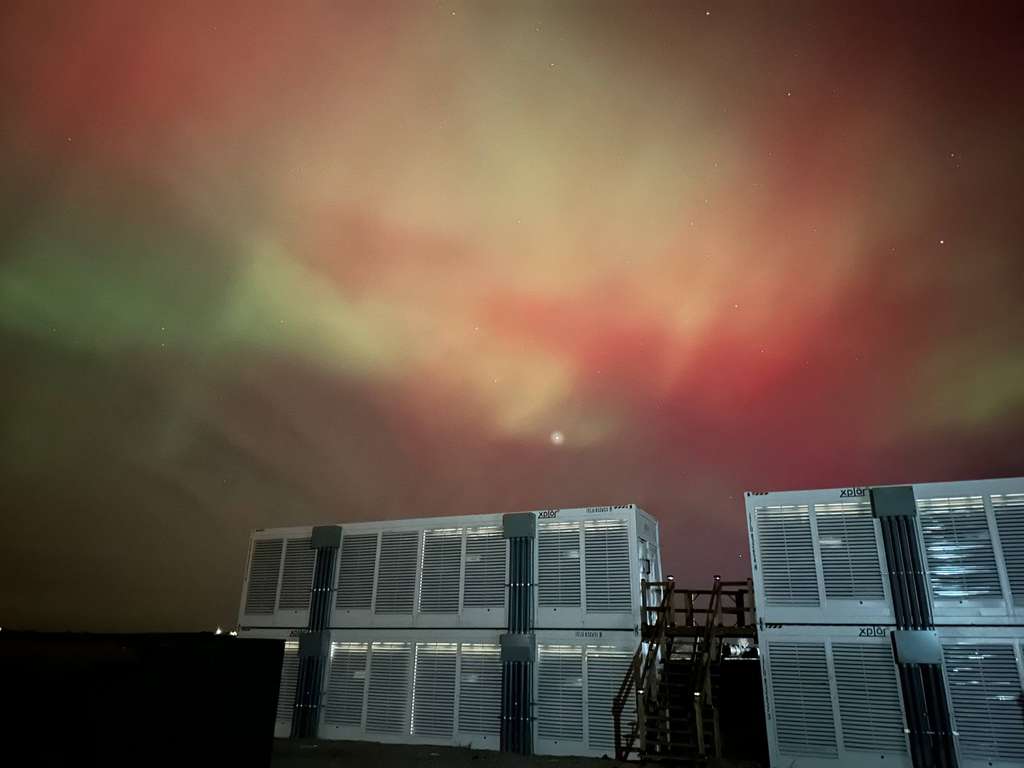Xplor Energy data center containers under aurora borealis